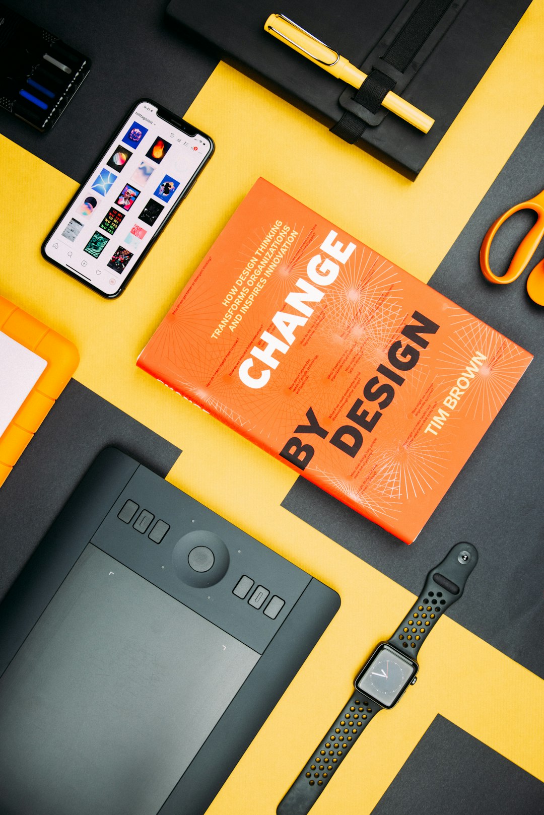 change-by-design-by-tim-brown-book-beside-smartphone-iyanci0cyrk